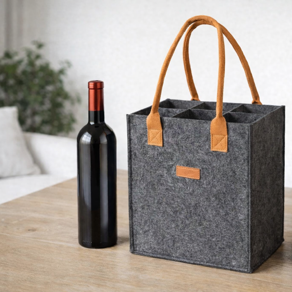 Gray wine tote with brown handles holding two bottles on a wooden table.